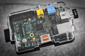 Detailed image of a Raspberry Pi microcomputer circuit board in a clear case.